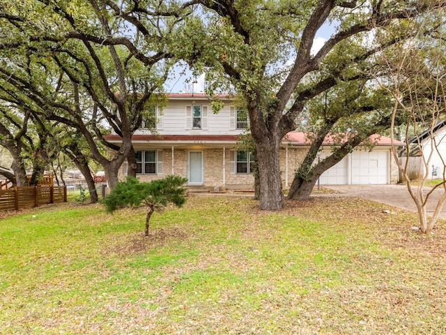 view of front of property featuring a garage and a front lawn