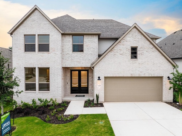 228 Running Fawn, Georgetown, TX 78628 - french country home with a shingled roof, driveway, brick siding, and a front lawn