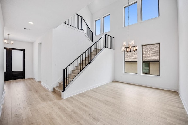 228 Running Fawn, Georgetown, TX 78628 - entryway with a chandelier, stairway, wood finished floors, a towering ceiling, and recessed lighting