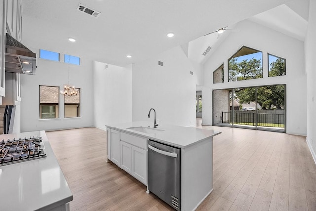 228 Running Fawn, Georgetown, TX 78628 - kitchen featuring stainless steel appliances, open floor plan, a chandelier, range hood, and light countertops