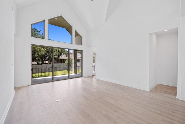 228 Running Fawn, Georgetown, TX 78628 - unfurnished living room featuring high vaulted ceiling and light wood-style flooring