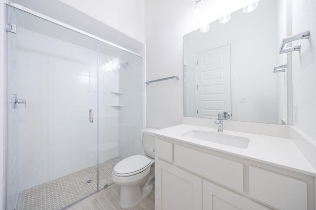 228 Running Fawn, Georgetown, TX 78628 - full bathroom featuring a stall shower, vanity, and wood finished floors