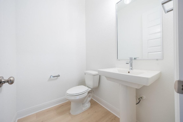 228 Running Fawn, Georgetown, TX 78628 - half bathroom with wood finished floors and toilet
