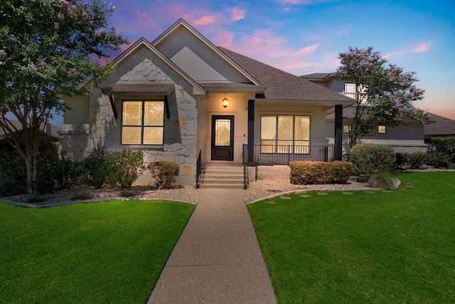 view of front of home with a yard and covered porch