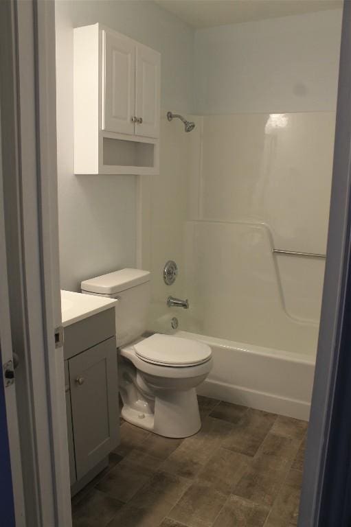 full bathroom featuring washtub / shower combination, vanity, and toilet