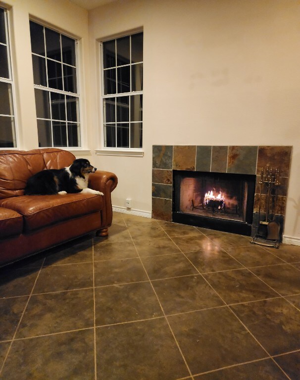 tiled living room featuring a fireplace