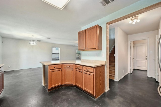 kitchen featuring hanging light fixtures and kitchen peninsula