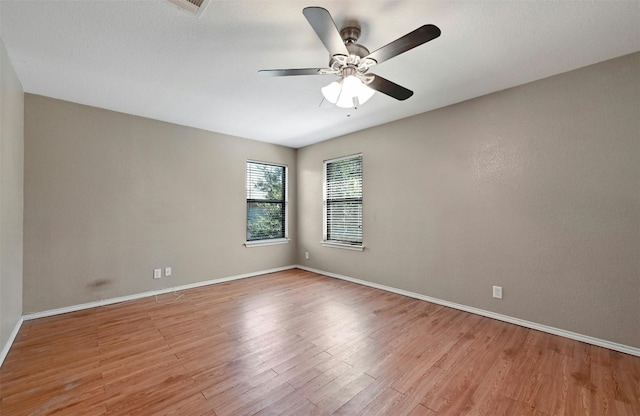 spare room featuring ceiling fan and light wood-type flooring