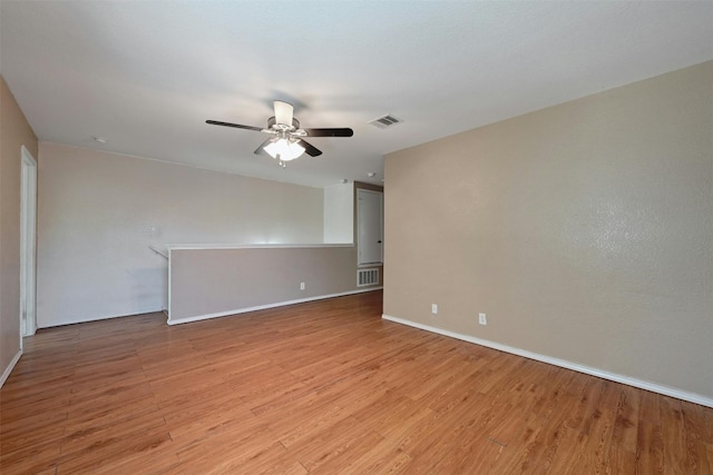 spare room with ceiling fan and light wood-type flooring