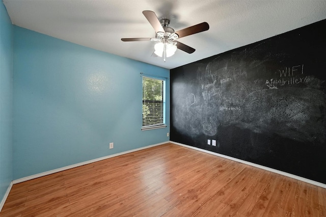 spare room with wood-type flooring and ceiling fan