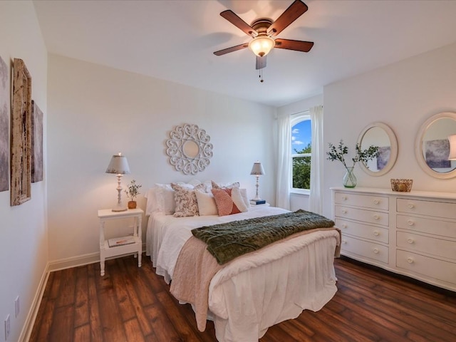 bedroom with dark hardwood / wood-style flooring and ceiling fan