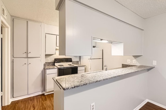 kitchen with white cabinetry, white refrigerator, electric range, light stone counters, and a textured ceiling