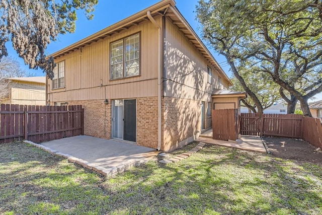 rear view of property with a yard and a patio area