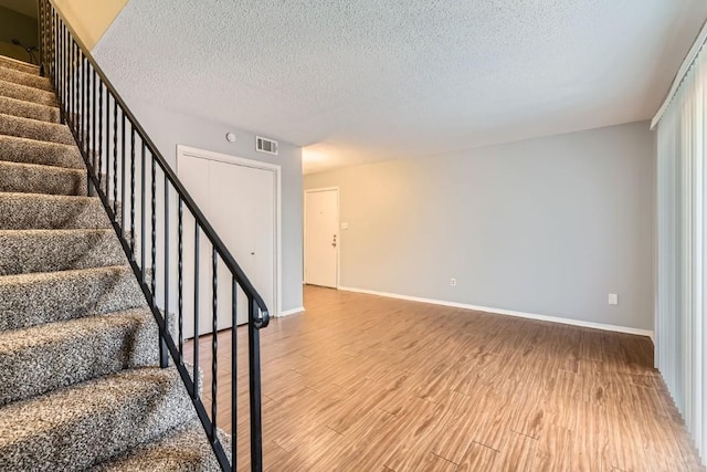 interior space with hardwood / wood-style flooring and a textured ceiling