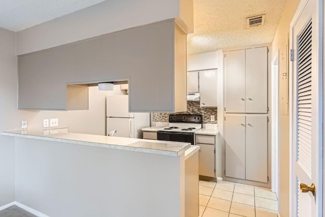 kitchen with light tile patterned floors, white appliances, backsplash, a textured ceiling, and kitchen peninsula