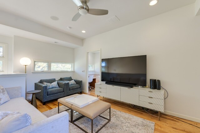 living room with ceiling fan and wood-type flooring