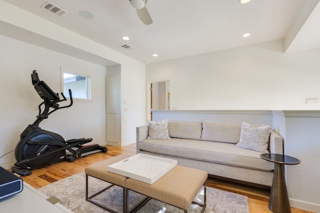 living room with light hardwood / wood-style flooring and ceiling fan