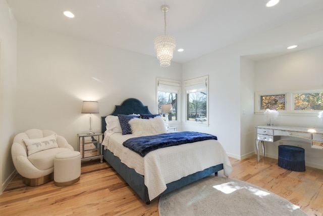 bedroom featuring hardwood / wood-style flooring and a chandelier