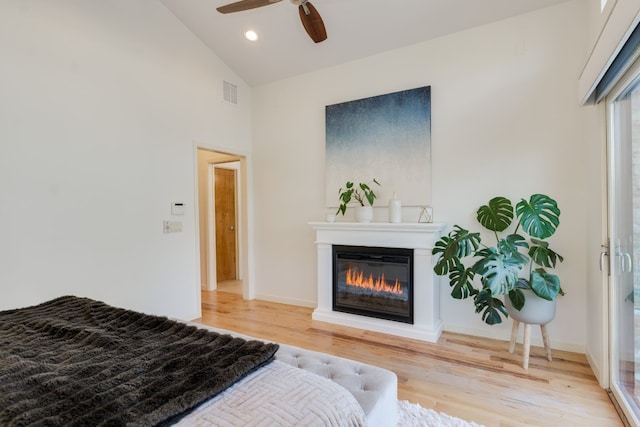 bedroom featuring wood-type flooring, high vaulted ceiling, and ceiling fan