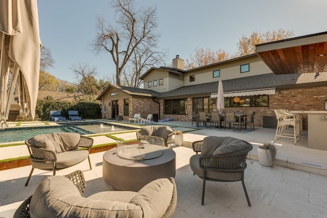 view of patio / terrace with exterior bar and an outdoor hangout area