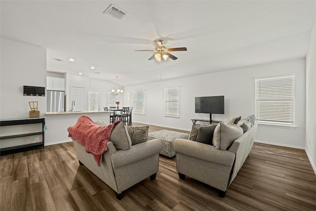 living room featuring sink, ceiling fan with notable chandelier, a wealth of natural light, and dark hardwood / wood-style floors