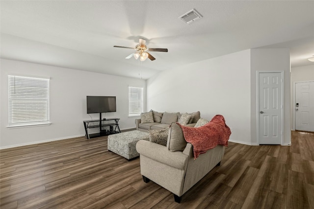 living room featuring dark hardwood / wood-style flooring and ceiling fan