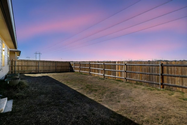 view of yard at dusk