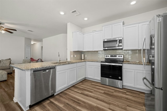 kitchen featuring white cabinetry, stainless steel appliances, and kitchen peninsula