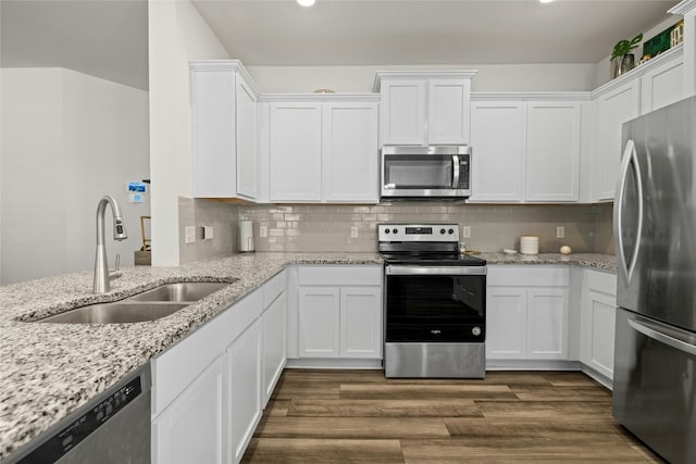 kitchen featuring white cabinetry, appliances with stainless steel finishes, sink, and dark hardwood / wood-style floors