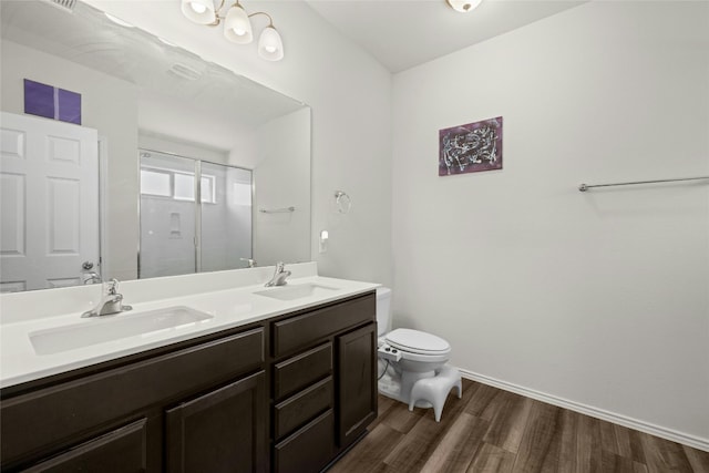 bathroom with hardwood / wood-style flooring, vanity, and toilet