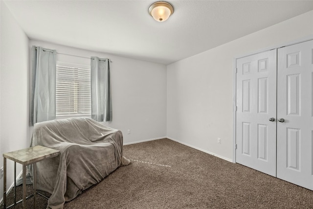 living area featuring dark carpet