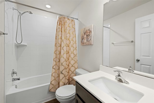 full bathroom with vanity, shower / tub combo with curtain, and toilet