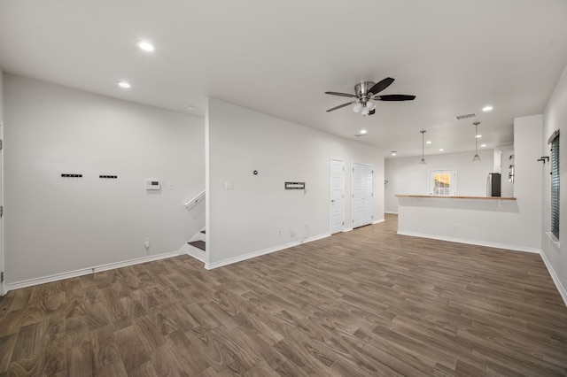 unfurnished living room with ceiling fan and wood-type flooring