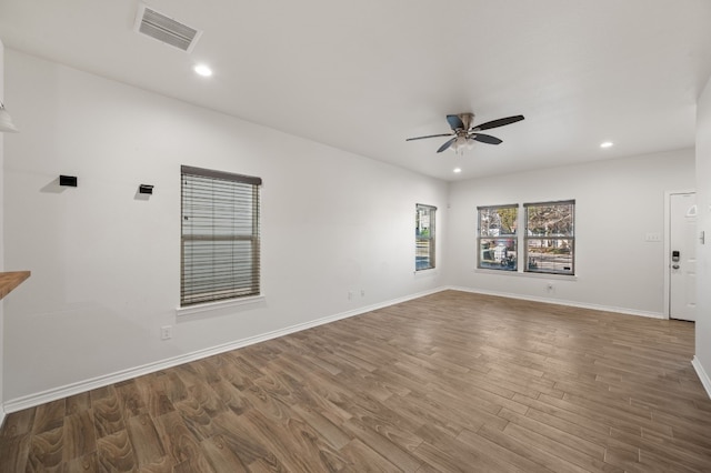 unfurnished living room featuring hardwood / wood-style flooring and ceiling fan