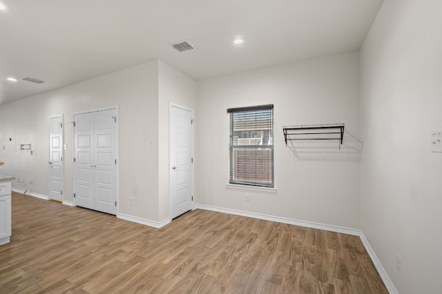 unfurnished room with light wood-type flooring