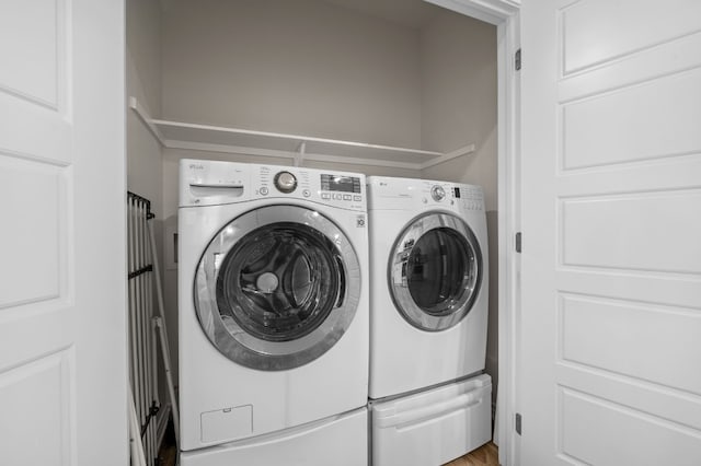 clothes washing area with washer and dryer