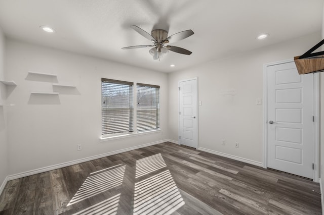 empty room featuring dark wood-type flooring and ceiling fan