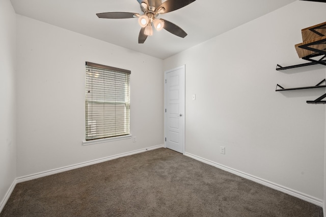 carpeted spare room featuring ceiling fan