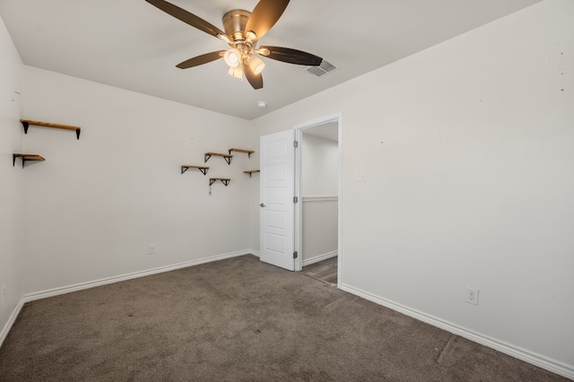 carpeted spare room featuring ceiling fan