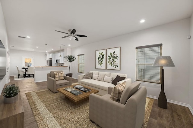 living room with hardwood / wood-style flooring and ceiling fan