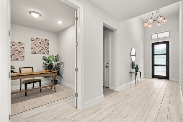 entryway featuring an inviting chandelier and light hardwood / wood-style floors