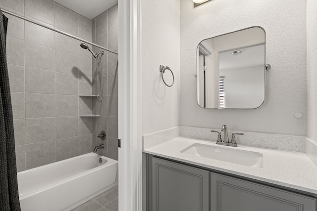 bathroom with tiled shower / bath, vanity, and tile patterned floors