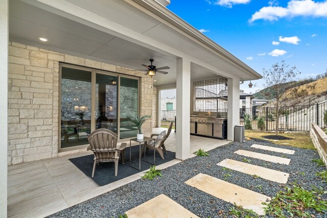 view of patio with ceiling fan and exterior kitchen