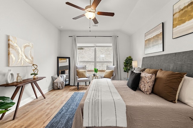 bedroom featuring lofted ceiling, ceiling fan, and light hardwood / wood-style flooring