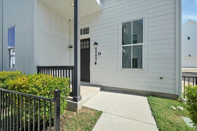 view of exterior entry featuring a porch