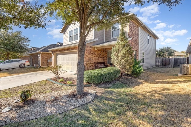 view of property featuring a garage, cooling unit, and a front yard