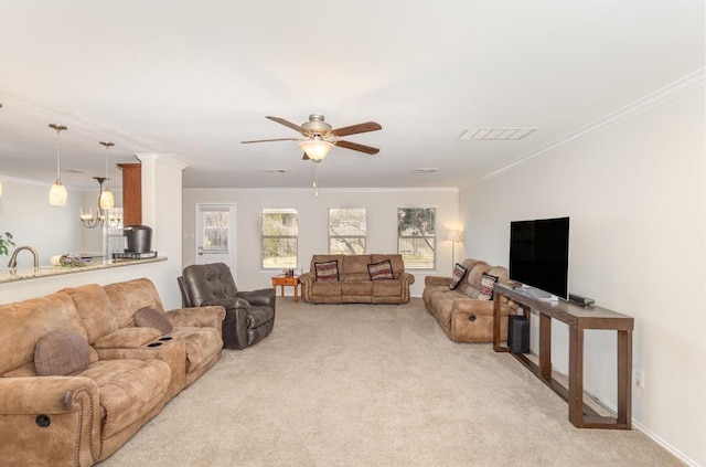 living room with ornamental molding, light colored carpet, and ceiling fan