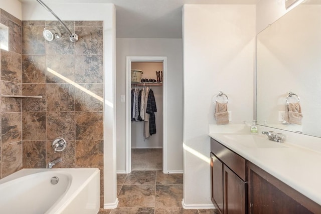 bathroom featuring tiled shower / bath combo and vanity