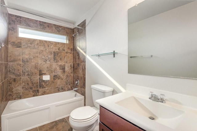 full bathroom with tiled shower / bath, vanity, toilet, and tile patterned floors