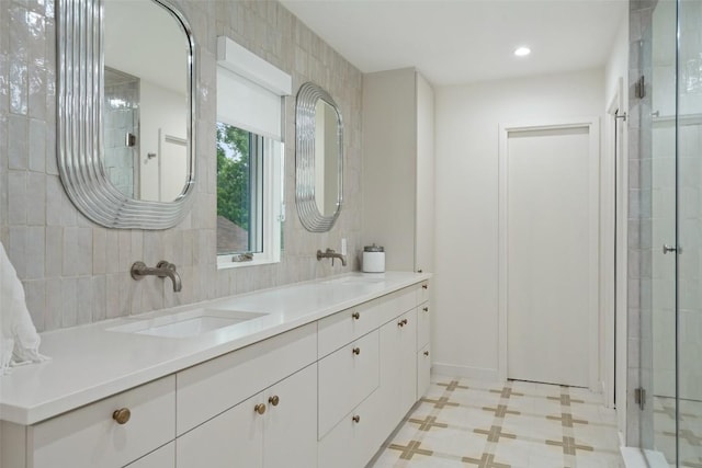 bathroom with vanity and a shower with door